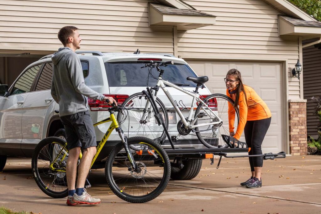 couple putting bicycles on bike rack