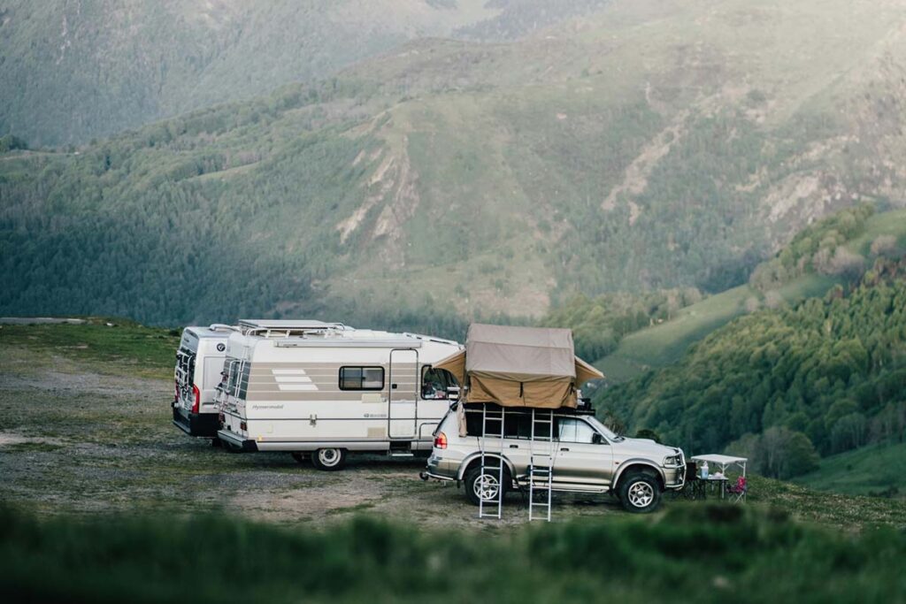 truck with overland accessories parked with 2 campers