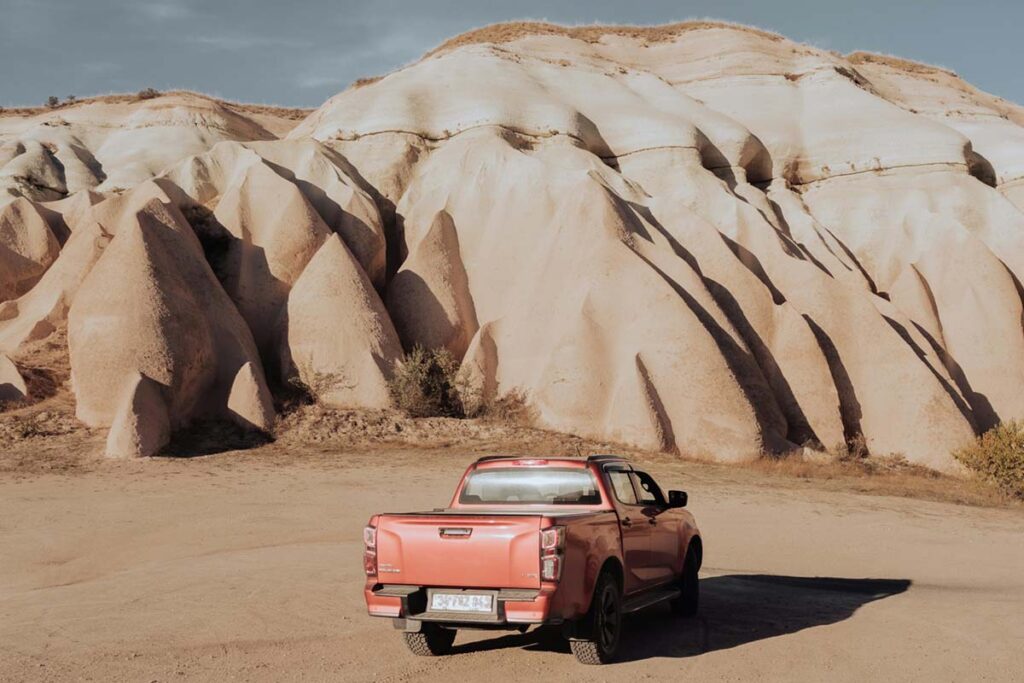 truck parked near rugged hills